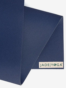 Jade Yoga brand blue yoga mat textured detail close-up, eco-friendly natural rubber, non-slip surface, professional exercise equipment.