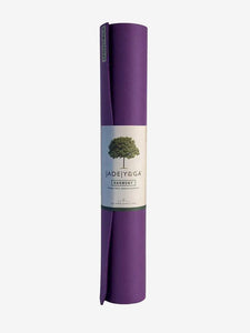 JadeYoga Harmony purple yoga mat rolled up shot from the side with label visible, eco-friendly fitness equipment, non-slip exercise mat.
