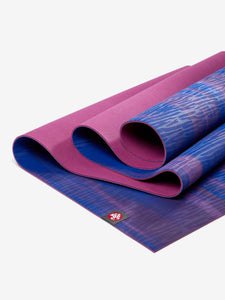 Rolled premium purple and blue yoga mats with patterned detail, side view, non-slip texture, fitness accessory.