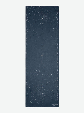 Navy blue celestial-themed yoga mat by Yoga Design Lab viewed from the front with star pattern design, non-slip surface, eco-friendly material, and alignment markers.