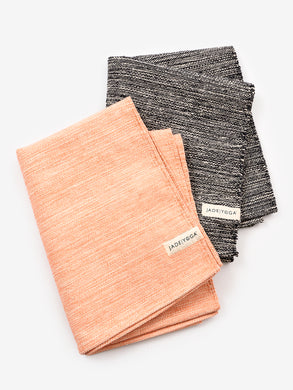 JadeYoga brand yoga towels, top view, coral and charcoal colors, textured design, fitness accessories, high-quality microfiber, non-slip, absorbent, perfect for hot yoga, pilates, workout gear.