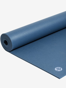 Rolled blue yoga mat with textured surface, side view, featuring a visible logo which may indicate the brand.