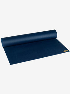 Navy blue premium yoga mat rolled halfway, visible branded label, non-slip texture, fitness equipment, top view shot, exercise accessory, durable material.