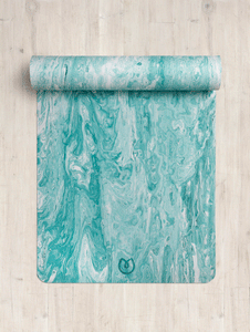 Aqua blue marbled yoga mat partially rolled up on a wooden floor, eco-friendly material, non-slip texture, top-down view