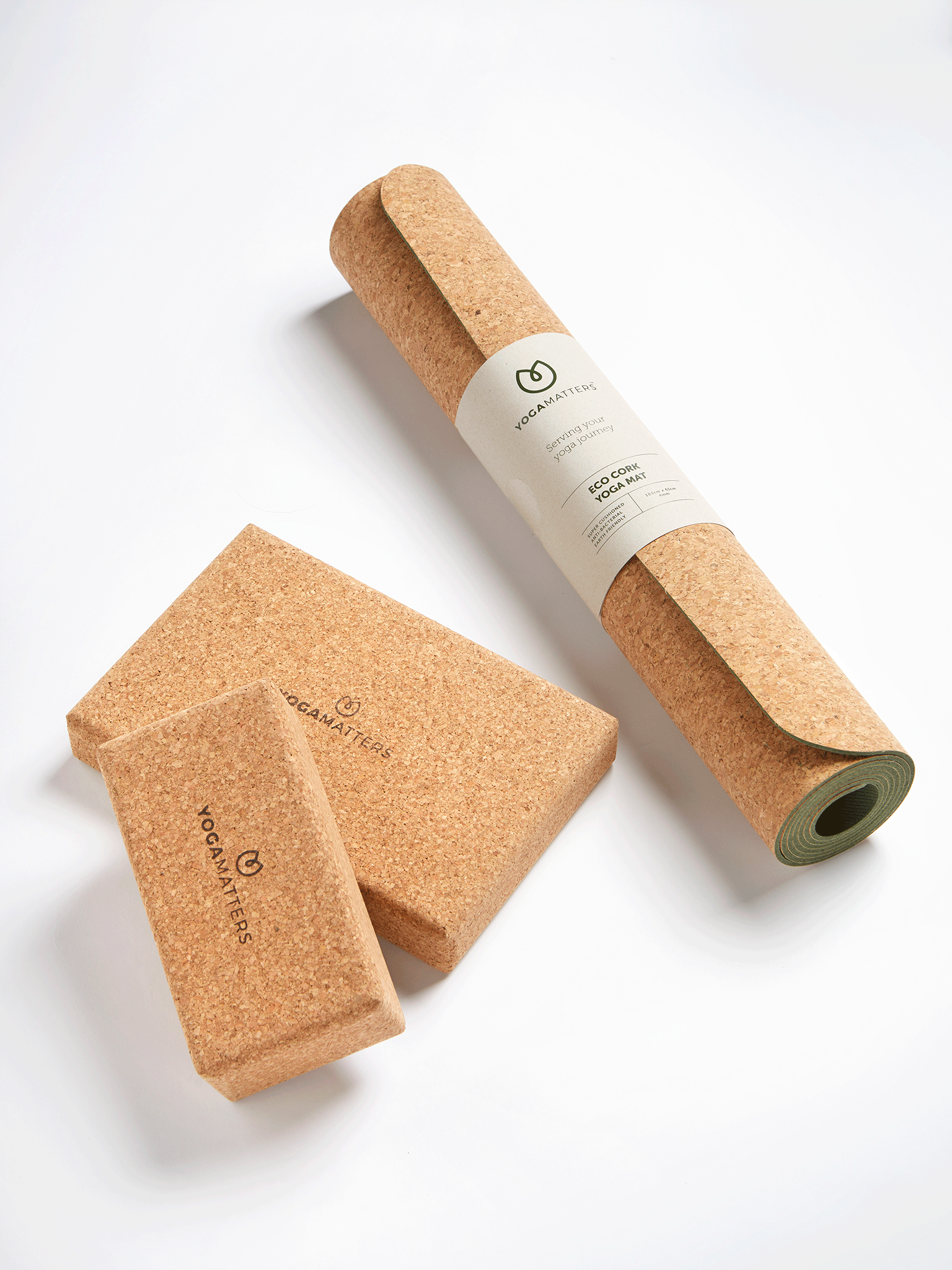 Eco-friendly cork yoga mat with matching blocks from YOGAMATTERS, sustainable fitness equipment, studio set on white background, top view