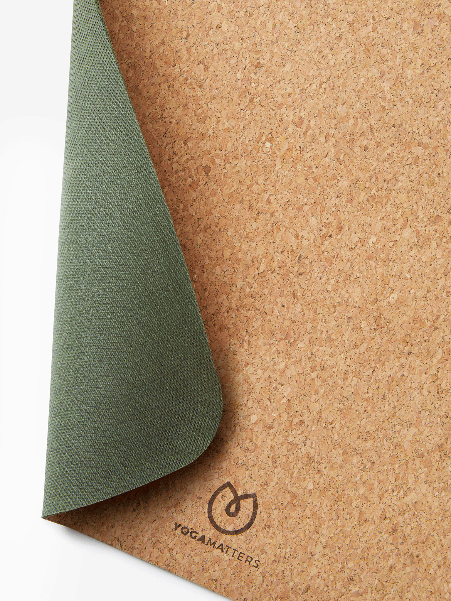 Yogamatters green and cork yoga mat close-up, eco-friendly non-slip surface, partially rolled revealing textured design, side shot with visible brand logo