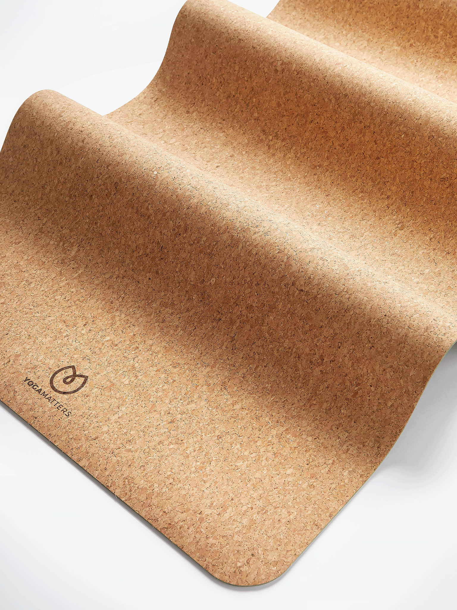 Eco-friendly cork yoga mat by YOGAMATTERS, close-up side view on white background