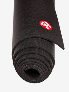 Black rolled-up yoga mat with red brand logo on top, eco-friendly material, non-slip texture, close-up side view, isolated on a white background.