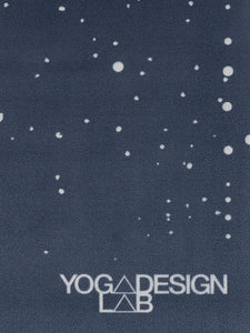 Navy blue YOGA DESIGN LAB mat with white dots pattern, textured non-slip surface, eco-friendly material, top-view shot of yoga accessory.