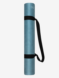 Teal blue rolled yoga mat with black carrying strap, side view, textured surface design.