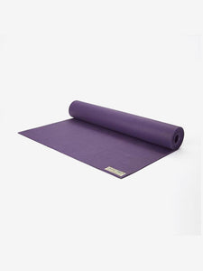 Purple yoga mat partially rolled out with visible brand tag on white background, side view