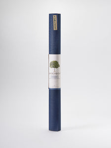 JadeYoga Voyager yoga mat in navy blue rolled up front view with label and logo on white background.