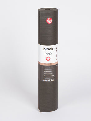 Manduka Black PRO Yoga Mat Rolled Up Front View with Logo and Product Information on White Background
