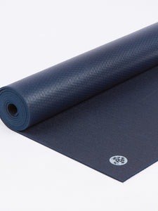 Navy blue textured yoga mat partially rolled side view with visible brand logo