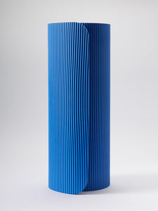 Blue textured yoga mat rolled up, front view on a white background.
