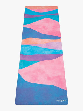 Colorful YogaDesign Lab yoga mat with wave pattern in shades of blue, pink, and purple, eco-friendly non-slip mat, full length front view.