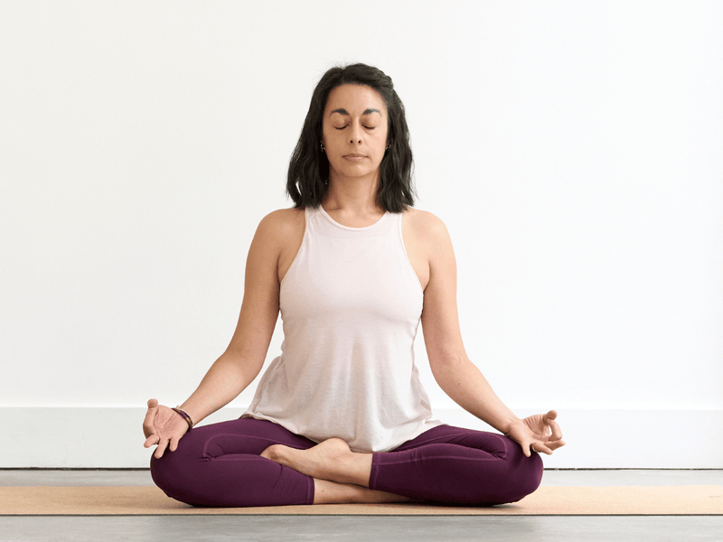 Person sitting cross-legged in Easy Pose (Sukhasana) with an upright spine and relaxed posture.