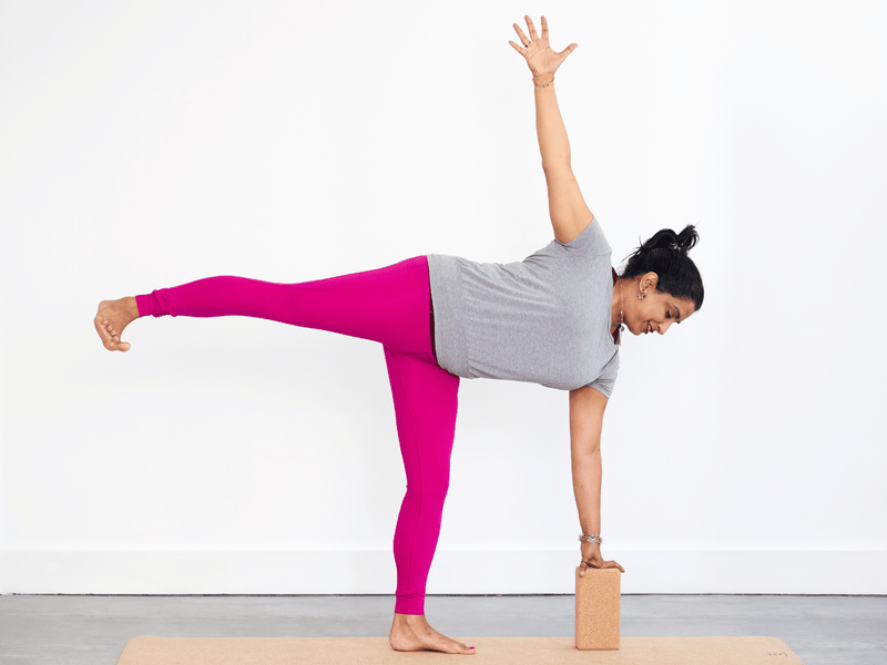 Person practising Half Moon Pose (Ardha Chandrasana), balancing on one leg and one hand with the opposite leg extended behind and the upper arm reaching upwards.