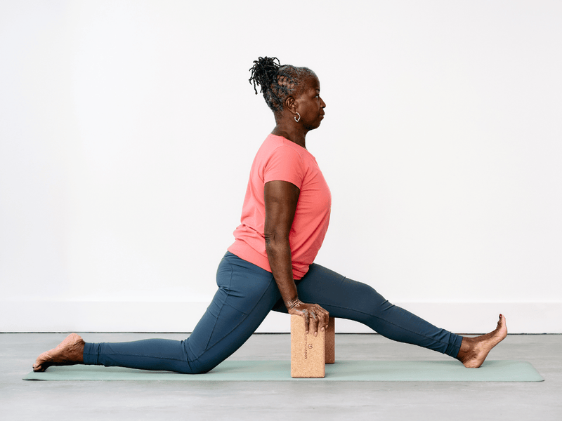 Person practising Half Splits Pose (Ardha Hanumanasana) with a yoga brick beneath each hand for support and stability.