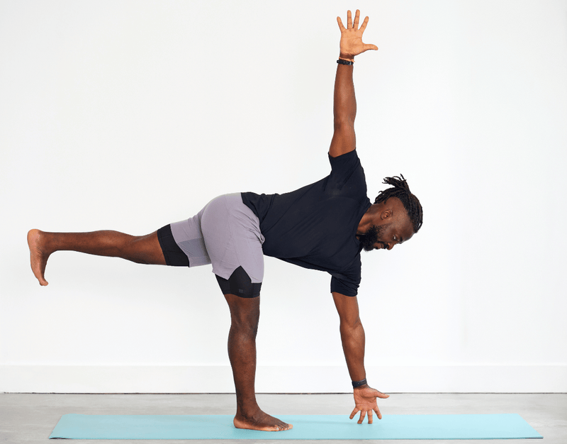 Person practising Revolved Half Moon Pose (Parivrtta Ardha Chandrasana), balancing on one leg with the opposite leg extended behind and the torso twisting open with one arm reaching upwards.