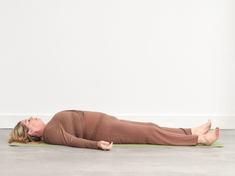 Person laying in Savasana pose