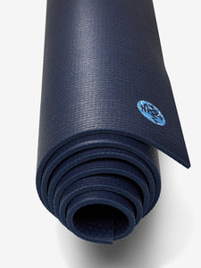Navy blue textured yoga mat rolled up, with a visible branded logo, non-slip surface, shot from the side on a white background