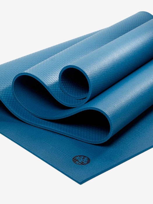 Blue textured yoga mat partially rolled with visible brand logo, non-slip exercise mat, eco-friendly material, isolated on white background, top view.