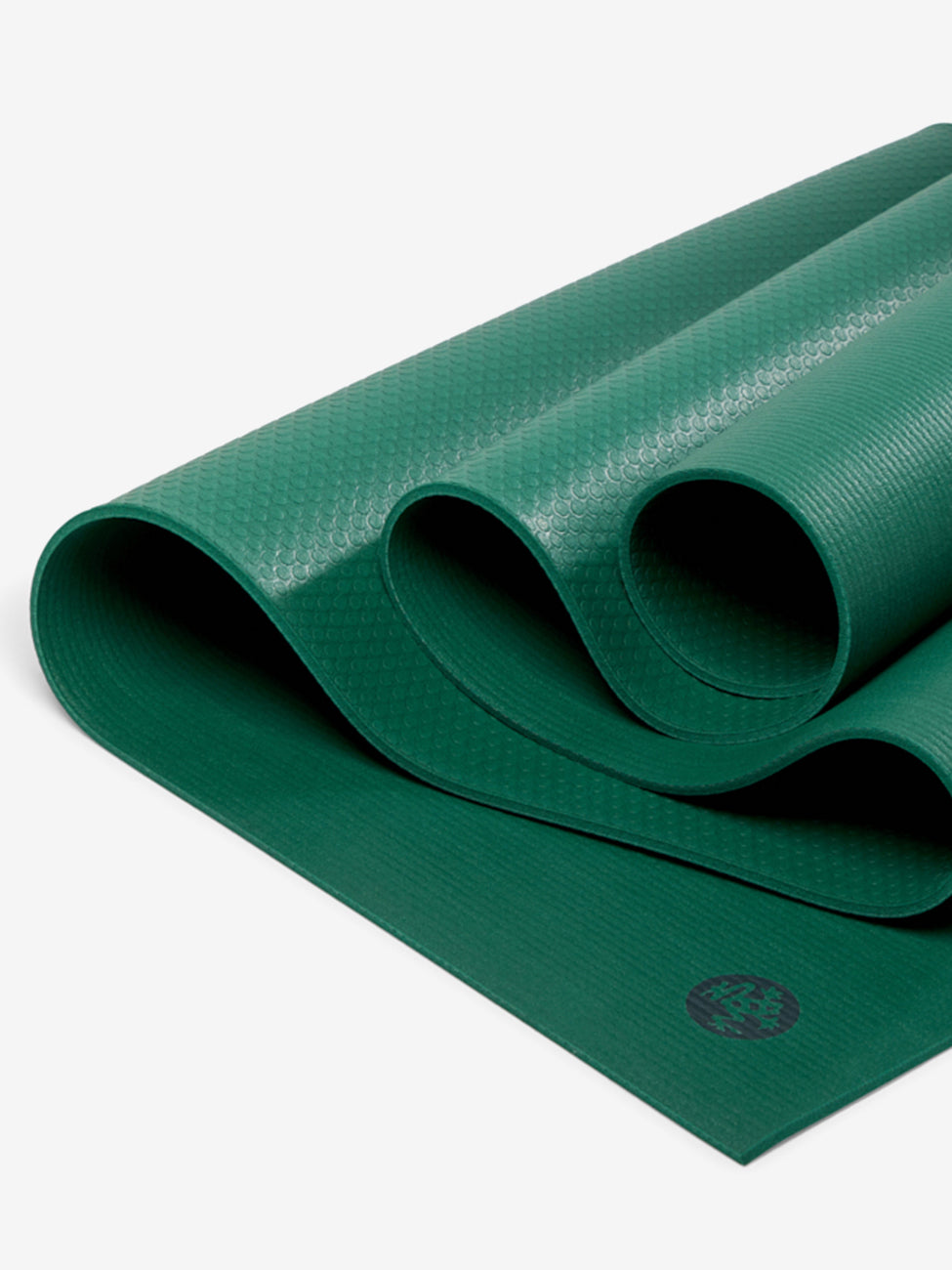 Green textured yoga mat partially rolled with visible logo, eco-friendly non-slip surface, photographed from above.