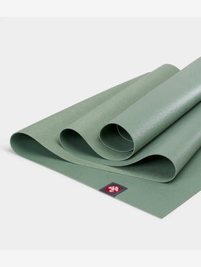 Rolled green Mnduka yoga mat, textured, non-slip surface, premium eco-friendly material, close-up shot.