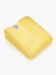 Yellow Liforme yoga mat folded on white background with visible brand logo, eco-friendly grip design, luxury cushioning, side shot.