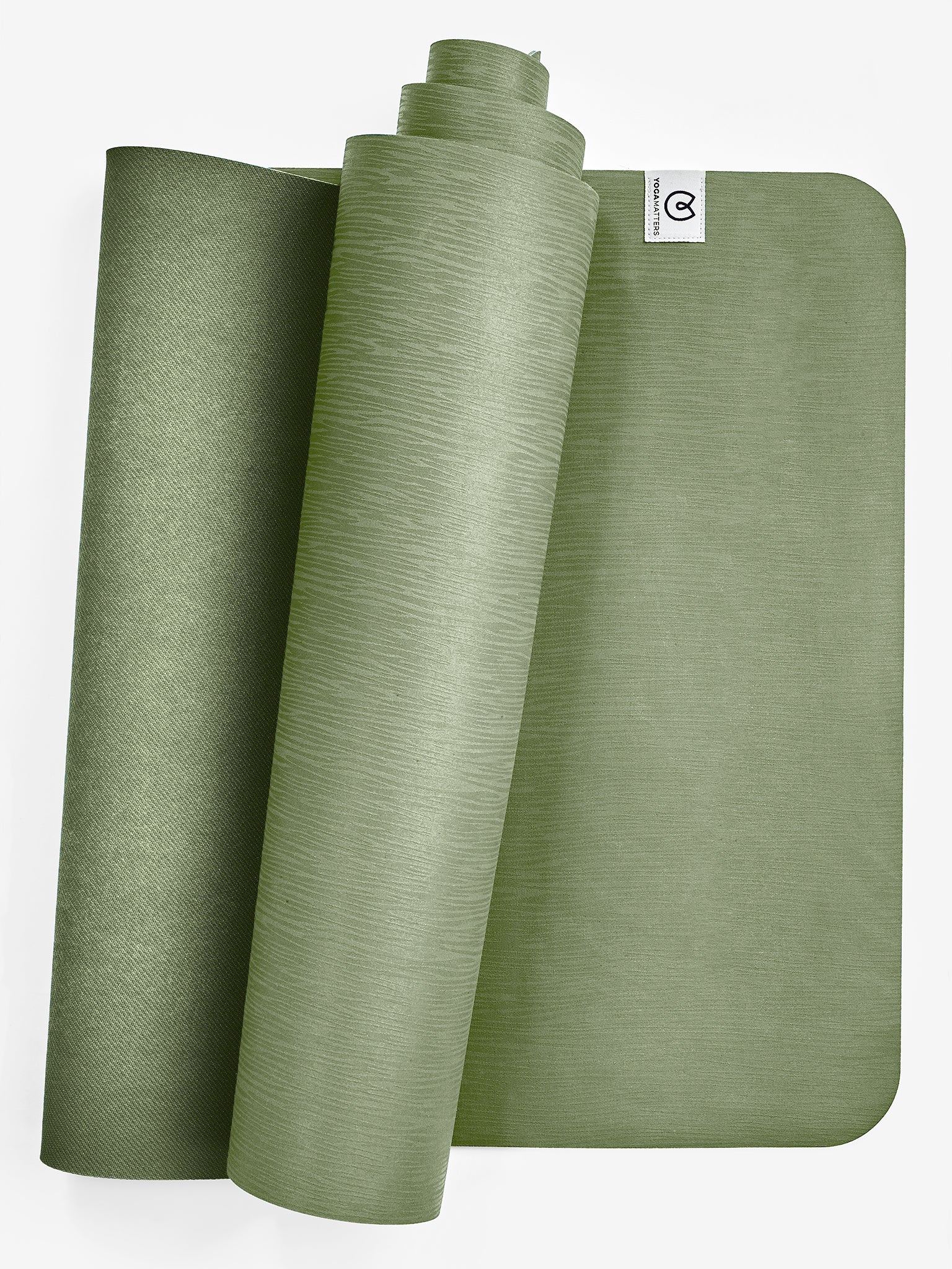 Green textured yoga mat partially rolled with visible brand tag on top right, eco-friendly non-slip exercise mat, front view, studio shot for fitness and wellness.