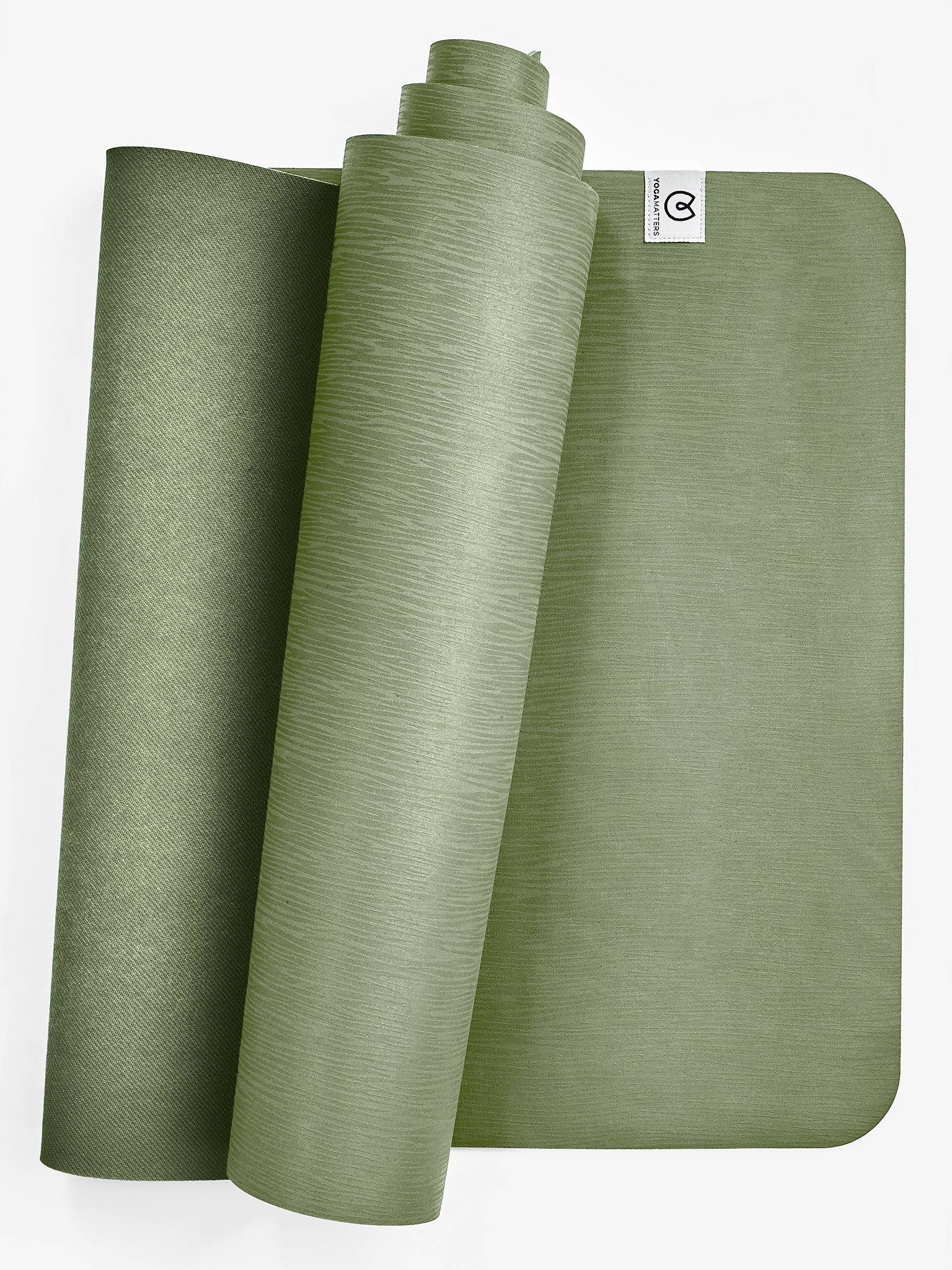 Rolled and unrolled green yoga mat side view with visible brand logo, non-slip texture, premium exercise mat for fitness, yoga, and pilates, isolated on white background.