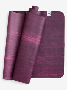 Purple yoga mat rolled and unrolled showing texture, top view, non-slip surface, exercise equipment for fitness and meditation