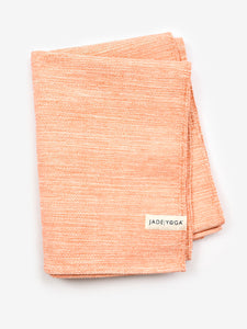 Coral textured yoga towel from JadeYoga, eco-friendly high-quality yoga gear, top view on white background