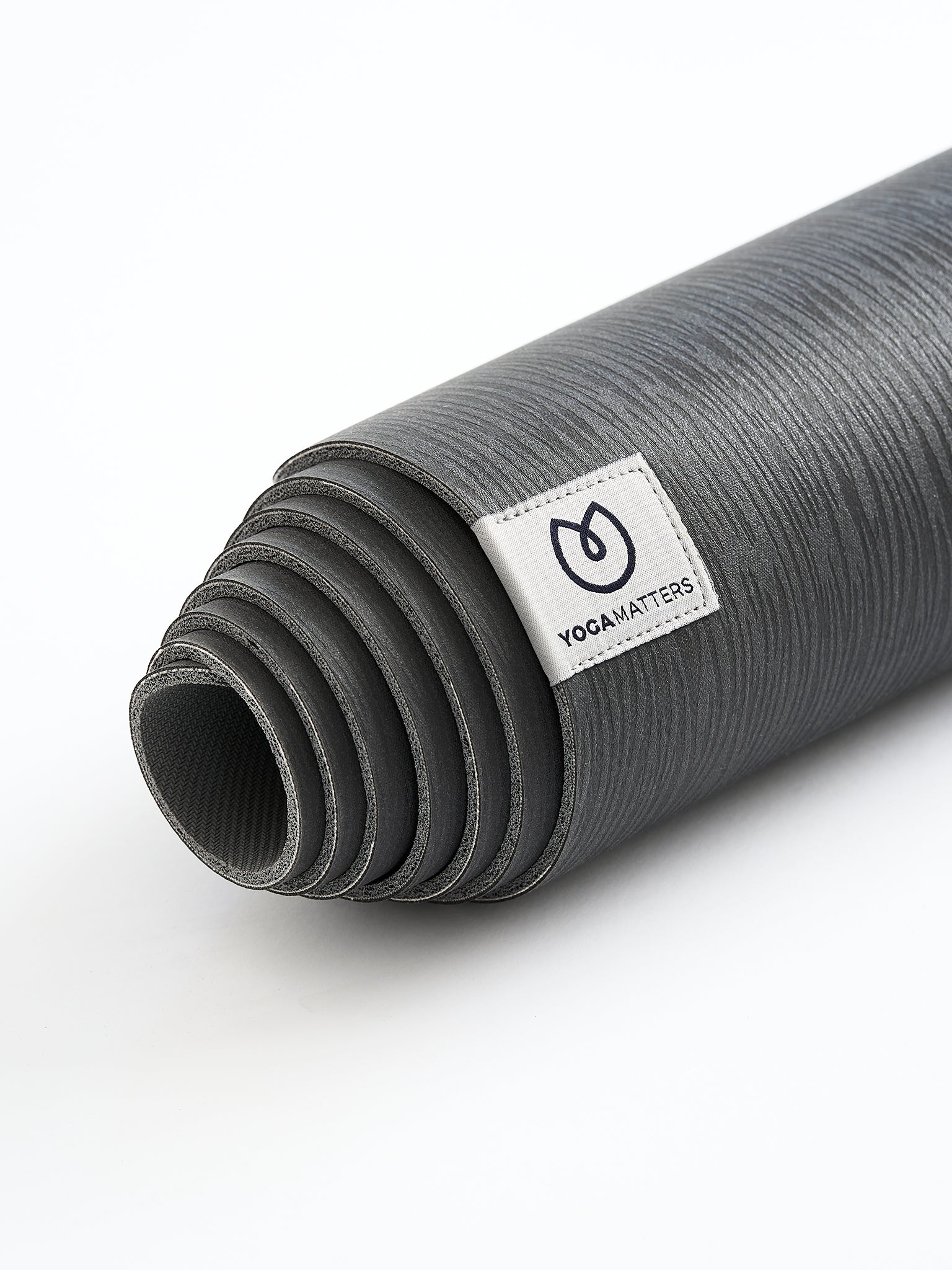 YogaMatters grey rolled-up yoga mat with textured surface, side view on white background