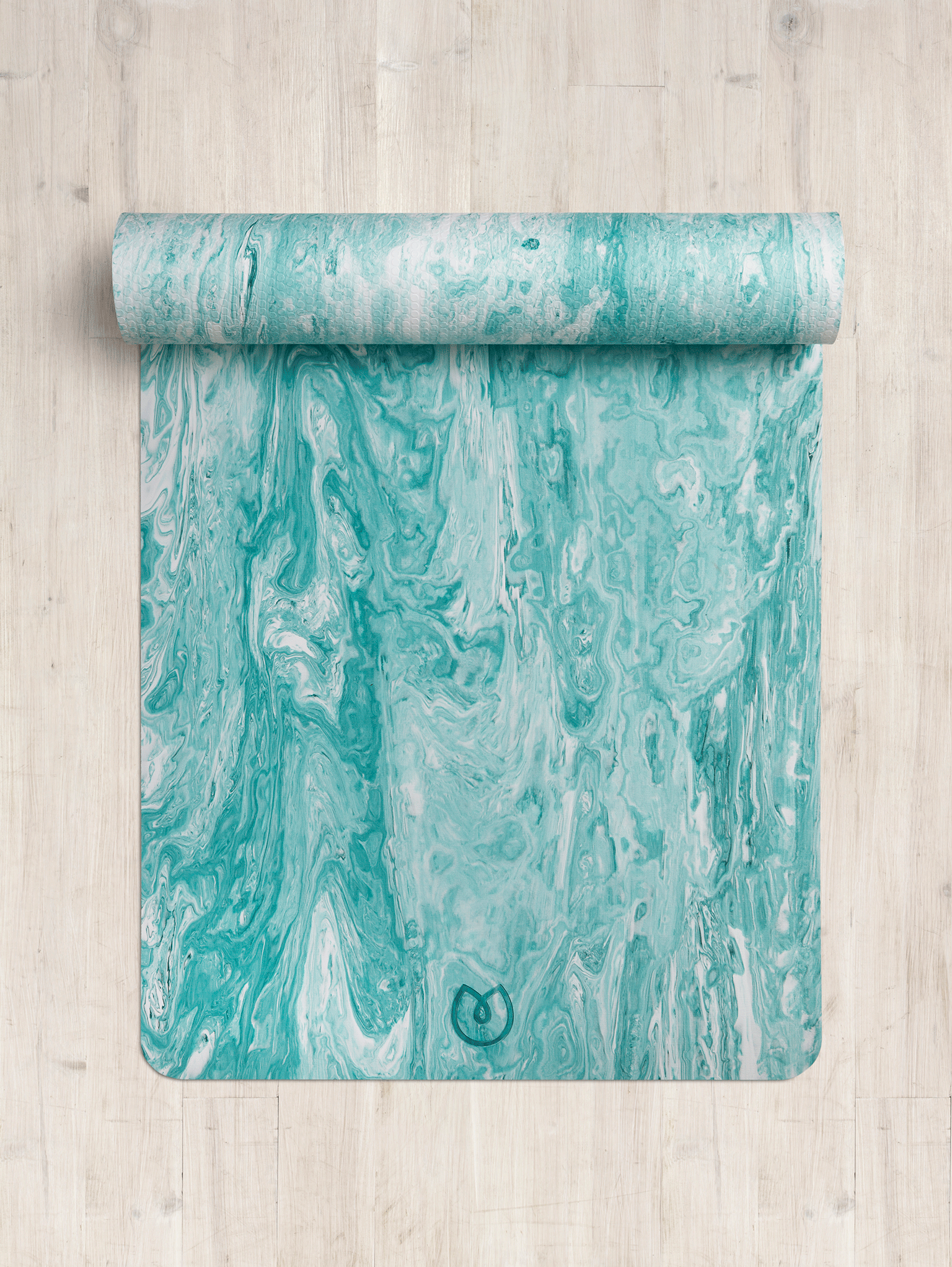 Aqua blue marbled yoga mat partially rolled up on a wooden floor, eco-friendly material, non-slip texture, top-down view