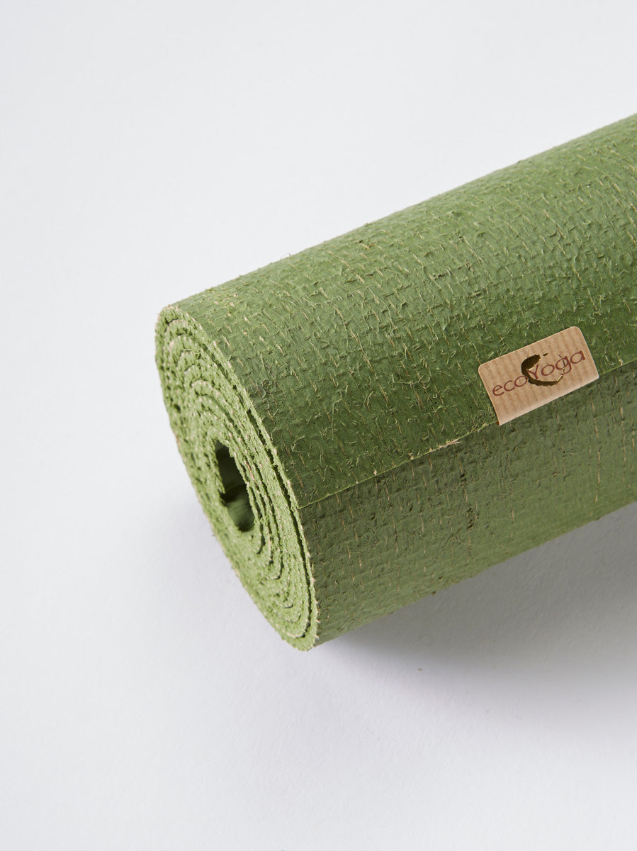Green textured EcoYoga brand yoga mat rolled up, side view on white background.