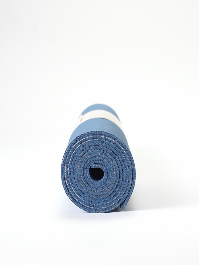 Blue yoga mat rolled up front view on white background