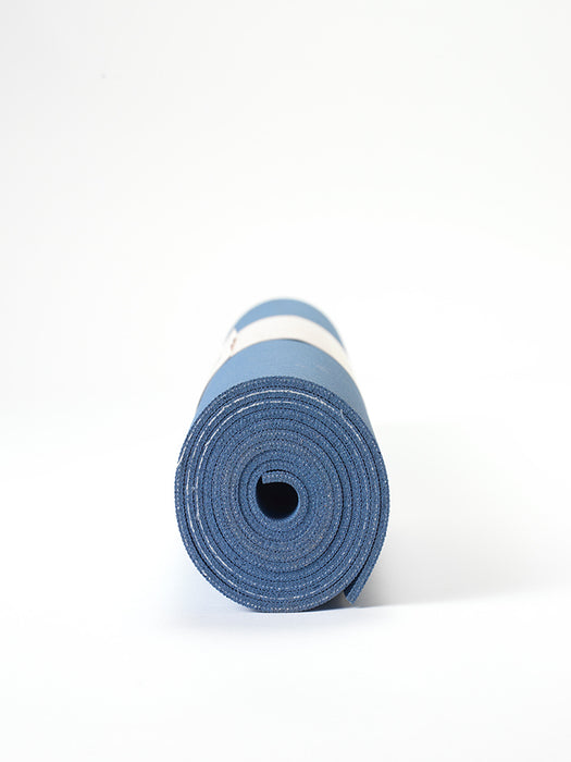 Blue yoga mat rolled up front view on white background