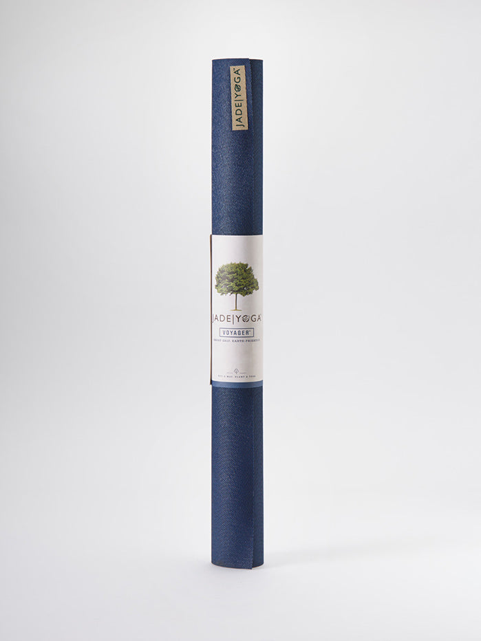 JadeYoga Voyager yoga mat in navy blue rolled up front view with label and logo on white background.
