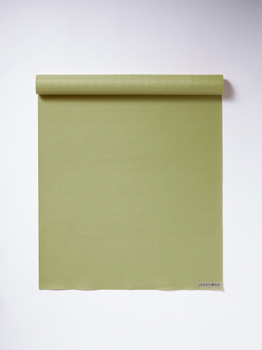 JadeYoga olive green yoga mat rolled from top on white background, high-quality textured surface, eco-friendly pilates exercise mat front view.