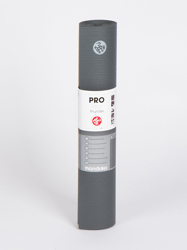 Manduka PRO Lite Thunder Gray Yoga Mat, rolled front view with logo and packaging, non-slip surface, high-performance, eco-friendly exercise mat.