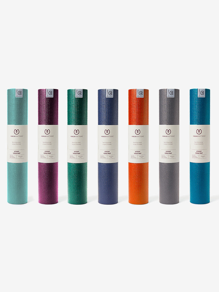 Row of Yoga Matters brand yoga mats in various colors displayed vertically with logos visible, front view, non-slip textured design for improved grip during yoga postures